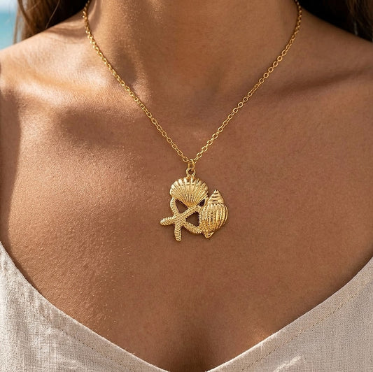 Starfish, seashell and clam pendant necklace worn at the neckline
