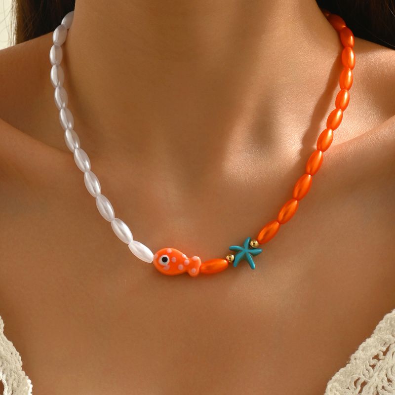 Orange and white beaded fish and starfish necklace