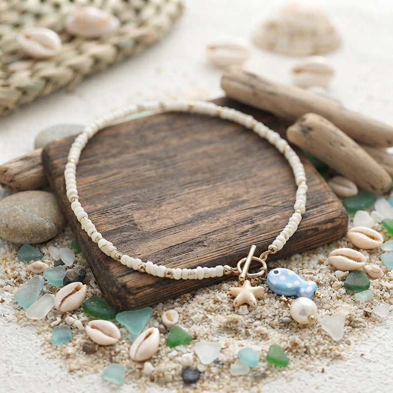 White and gold ceramic fish and pearl necklace